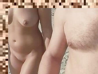 stepdaughter walks with her stepfather on a nudist beach