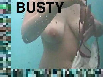 Busty milf takes a shower in a beach cabin and gets filmed with a spy cam
