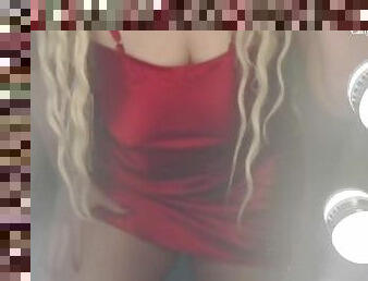 Blonde in front of mirror in a red evening dress before going out!