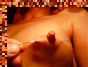 Pinching her nipples before milf needle play