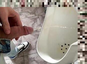 Guy peeing in public office toilet