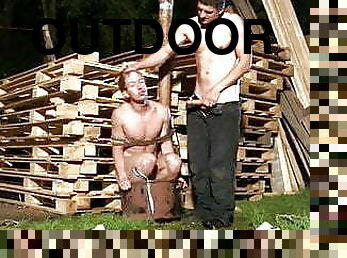 Bound boy made to suck cock outdoors