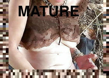 Sexy mature masturbates outside