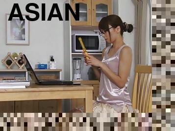 An Asian girl in glasses toys her ass with a vibrator