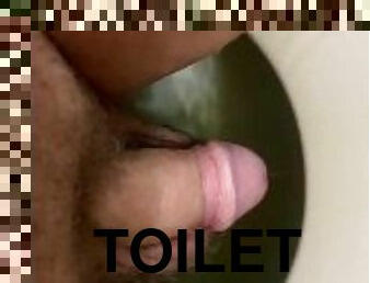 Peeing while sitting on toilet