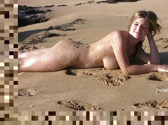 All natural Danielle shows her nude body on a beach