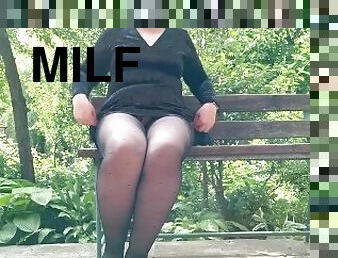 Naughty milf in pantyhose pissing in the park on a bench rear view