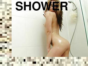 Small titted girl in bikini washes her sexy body in the shower