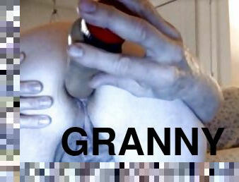 Granny fucks herself with a toy in anal