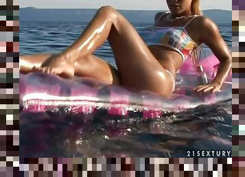 Divine blondie is floating on the lake with her legs wide open