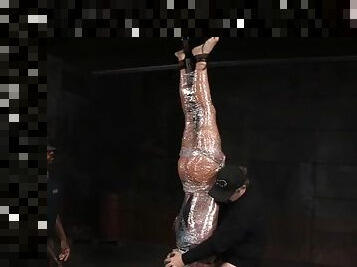 Upside down girl wrapped in plastic and mouth fucked