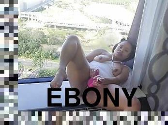 Ebony MILF fucks her pussy in front of hotel window til she squirts all over the floor!