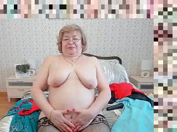 Mature strips on webcam and masturbates