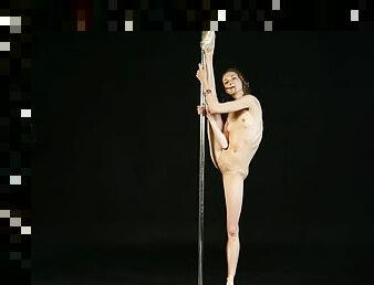 Gorgeous Nude Ballerina Dances On A Pole. Girl Dancer Spreads Her Flexible Long Legs Wide