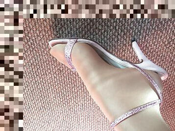 My feet close up looking in shiny glossy pantyhose and sexy pink heels sandals.