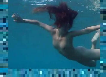 Beauty looks like a mermaid swimming in the ocean