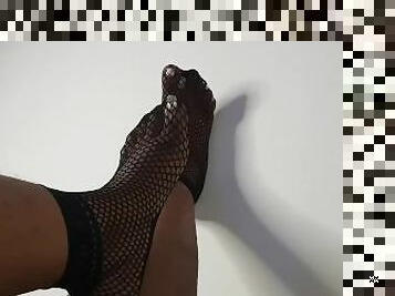 Just feet in fishnets socks tease