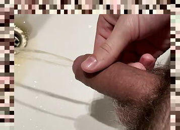 Pissing in the toilet in the bathroom sink