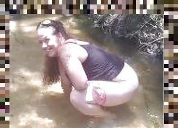 Cute Long Hair Girl pulls down her jeans and panties and pees in popular spring creek