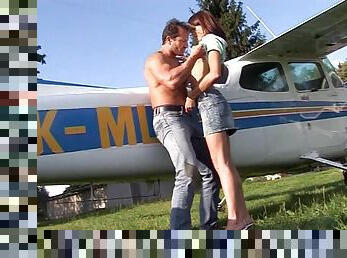 Pilot and a pretty girl get out of the plane and fuck in the grass