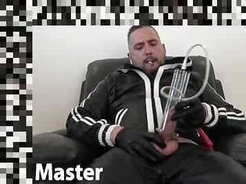 Uncut leather daddy pumps smokes cigar and uses masturbator on his dick in leather tracksuit PREVIEW