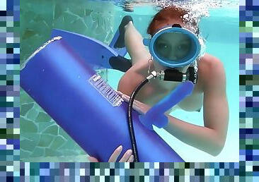 Scuba diving girl in a pool sucks on a dildo