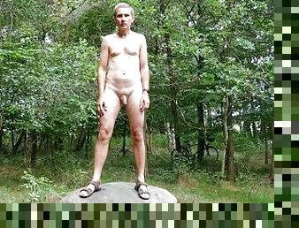 Nude posing on a rock